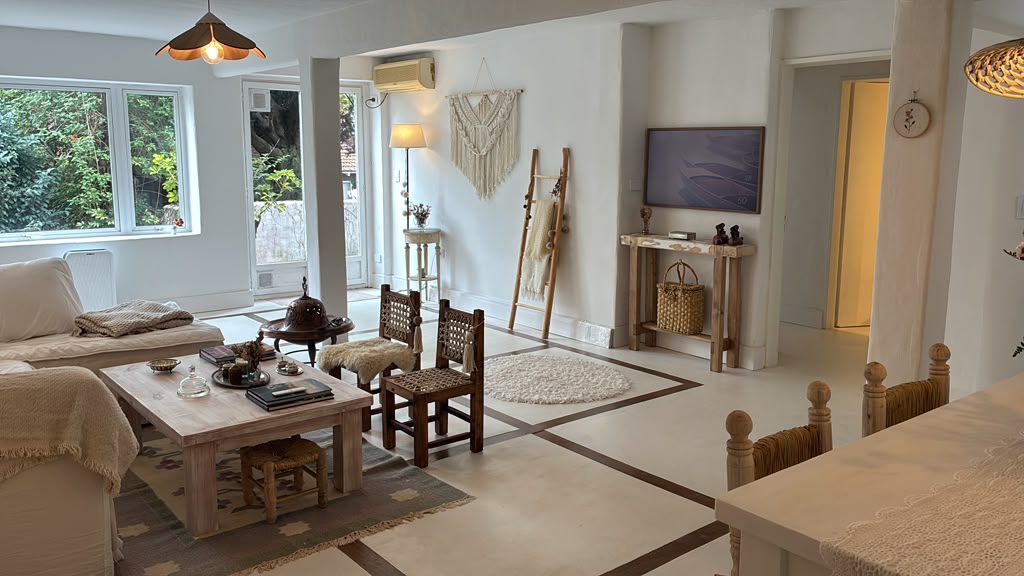 El mismo living ya decorado: sofá, alfombras, consola vintage y mobiliario cálido